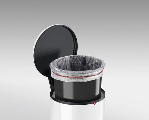 Photo of a small black waste bin with plastic inside. The lid is open