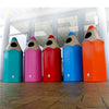5 large pencil shaped recycling bins in light blue, pink, red dark blue and orange situated in the hallway. 