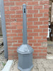 Grey Freestanding Cigarette Bin with a Keyhole Aperture and Narrow Chute.