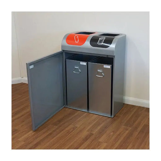 Double stream waste bin placed on a hallway. The magnetic front door is opened revealing two removable inner liners inside. 