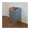 recycling bin with double waste stream and a galvanized steel outer shell. One receptableis orange, and the other is black, positioned in a hallway.