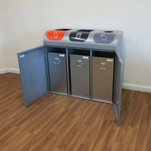 A recycling bin with 3 aperture. The two front door is opened, showing the three removable inner liner.