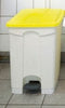 All plastic constructed pedal bin in white containing a yellow lid facing straight on