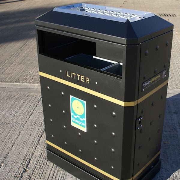 Black powder coated steel litter bin with slight peaked lid with ashtray.  Body finished with anti fly dimples and gold banding