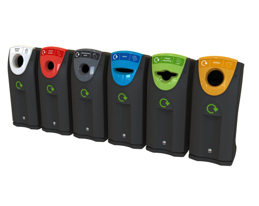 Photo of 5 recycling bins in black base color with different colored apertures and attached recycling labels, arranged from left to right: white, red, grey, blue, green and yellow.