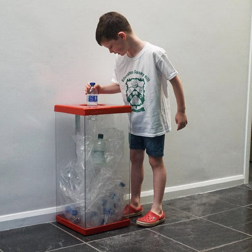 Transparent recycling bin with child disposing of plastc bottles
