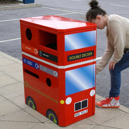 A person interacting with the Double Decker Bus Recycling bin.