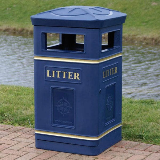 Freestanding blue Compass litter bin in location.  Standard aperture on each side and finished off with gold banding and litter text