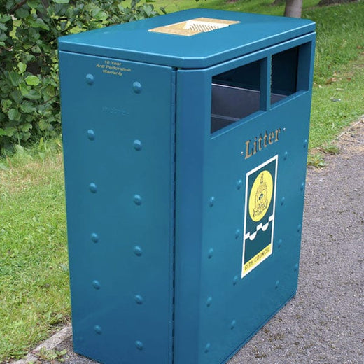 A side-view image presents a black, outdoor dual recycling bin with standard openings and a lid. It's embellished with laser-cut gold stickers.