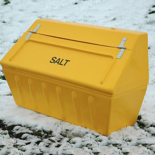 a large GRP salt bin in yellow, positioned on a road covered in ice.