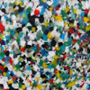 Close up view of the recycled plastic chippings. It has various colors of white, black, green, red, and blue.