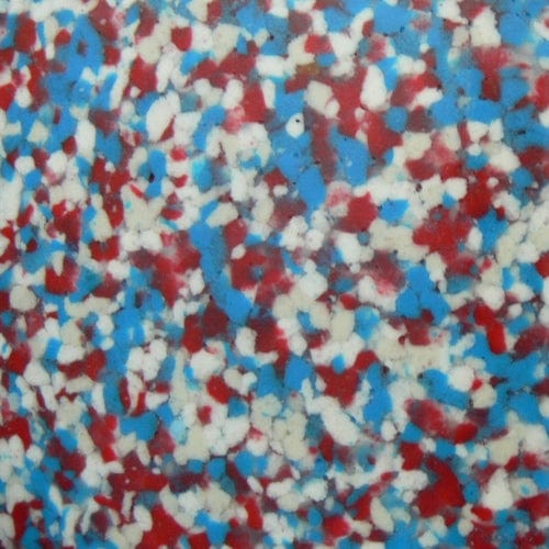 Zoom in photo of the multicolored recycled plastic chippings, featuring shades of white, red, and blue.