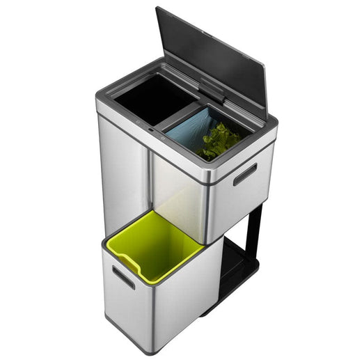 An overhead view of a 3-compartment trash bin with open lids and unattached lower unit.  The trash from the upper bin is visible.