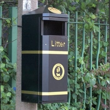 Post mountable litter bin with apex lid containing gold fitted ashtray.  Square aperture to the front, gold banding to top and bottom, litter wording in laser cut gold and tidyman logo