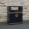 Large outdoor litter bin wth flat top, rectangular aperture to the front and back.  Gold banding to the top and bottom, litter and dog waste label to the centre