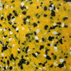 Close up photo of the recycled plastic chippings in mixed colors of yellow, white and black.