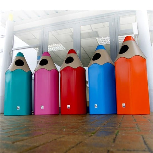 5 large pencil shaped recycling bins in light blue, pink, red dark blue and orange situated in the hallway. 