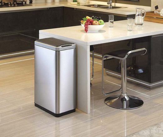 EKO Phantom Sensor Bin in a home setting, beside a dining table, blending style and functionality seamlessly.