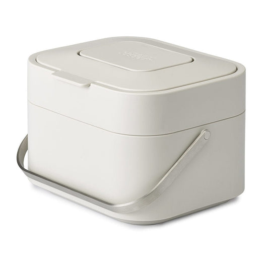 standalone photo of a white food waste caddy with lid tightly shut.