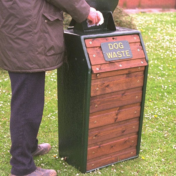 Dog waste litterbin with chute in the open position.  Dark oak slats with green surround