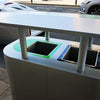 Hooded recycling bin with mixed recycling and general waste open apertures 