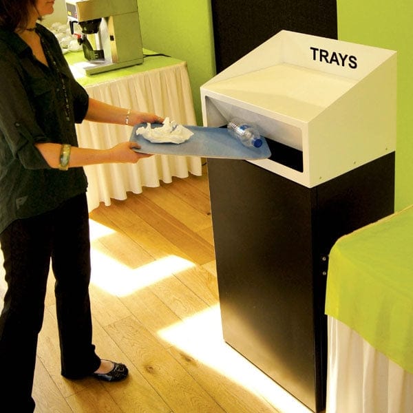 Internal litterbin with black base and white lid for trays, user emptying tray contents into push flap